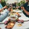 a group of people having a meal around an outdoor table